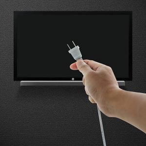 Hand pulling television plug Hand pulling television plug